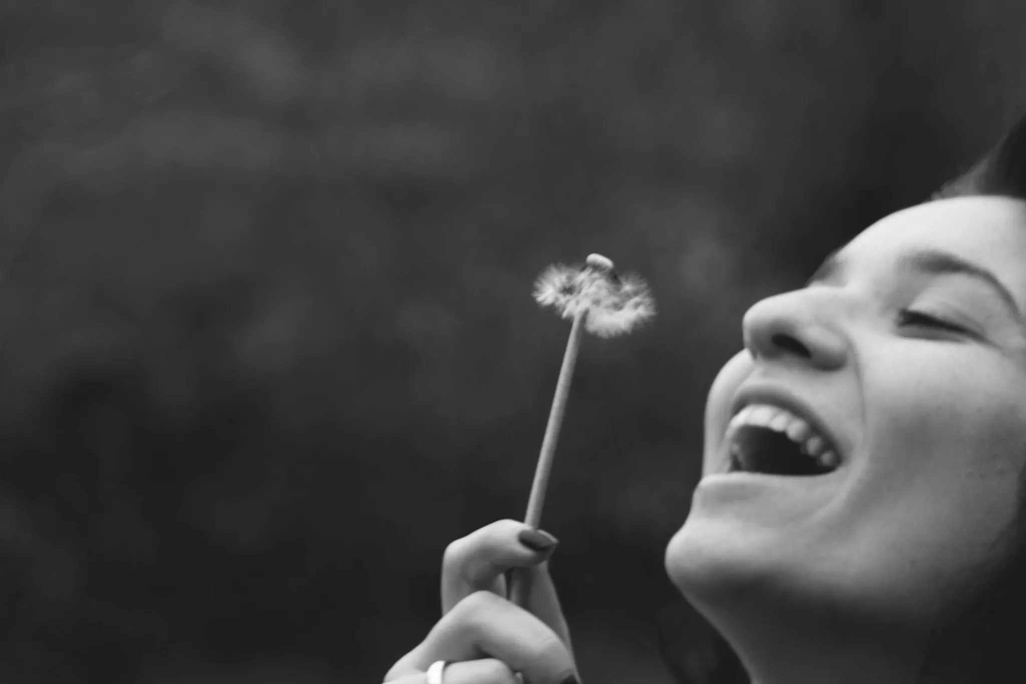 woman blowing flowers
